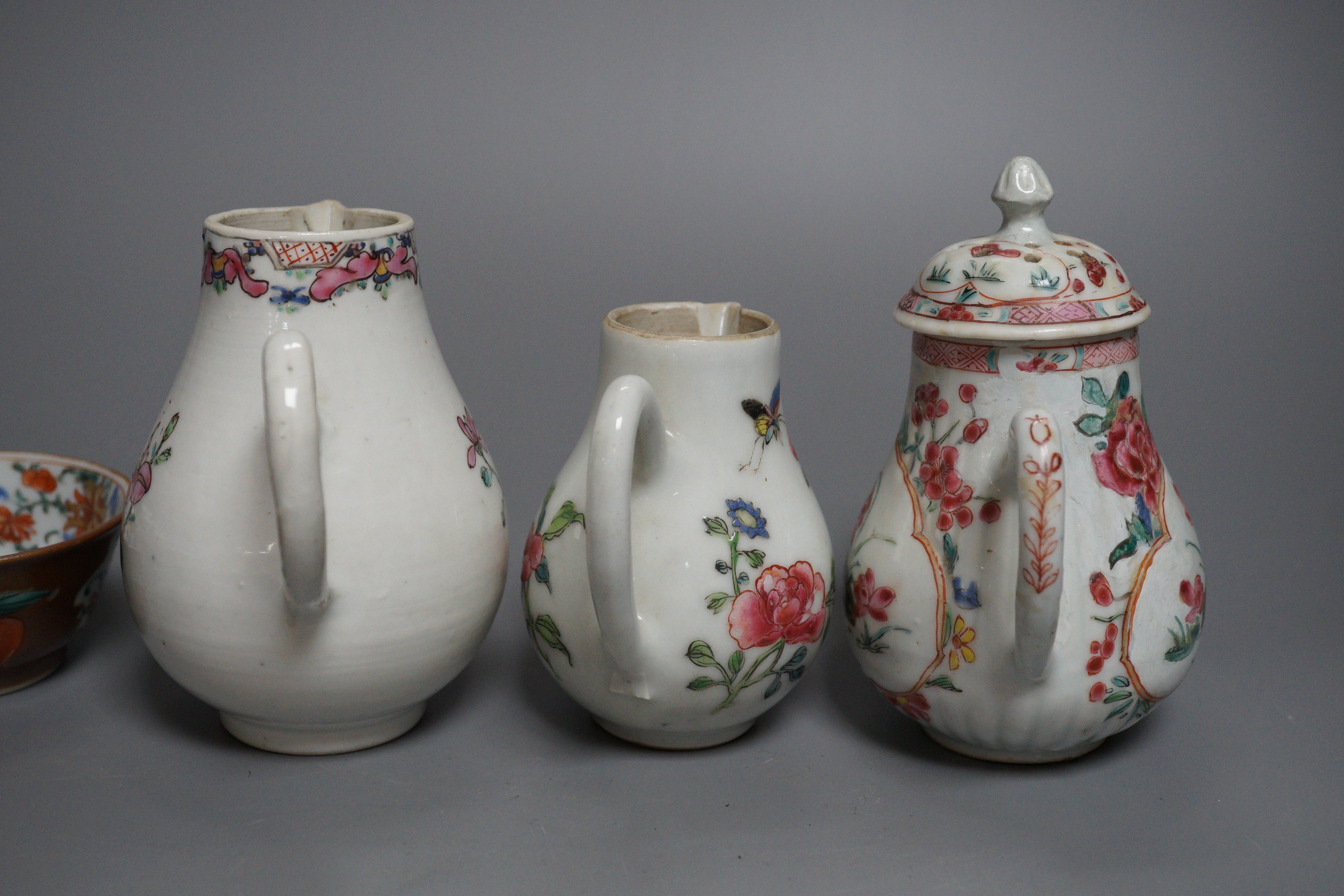 Three Chinese export famille rose cream jugs, one with pierced cover and three small bowls, 18th century and later